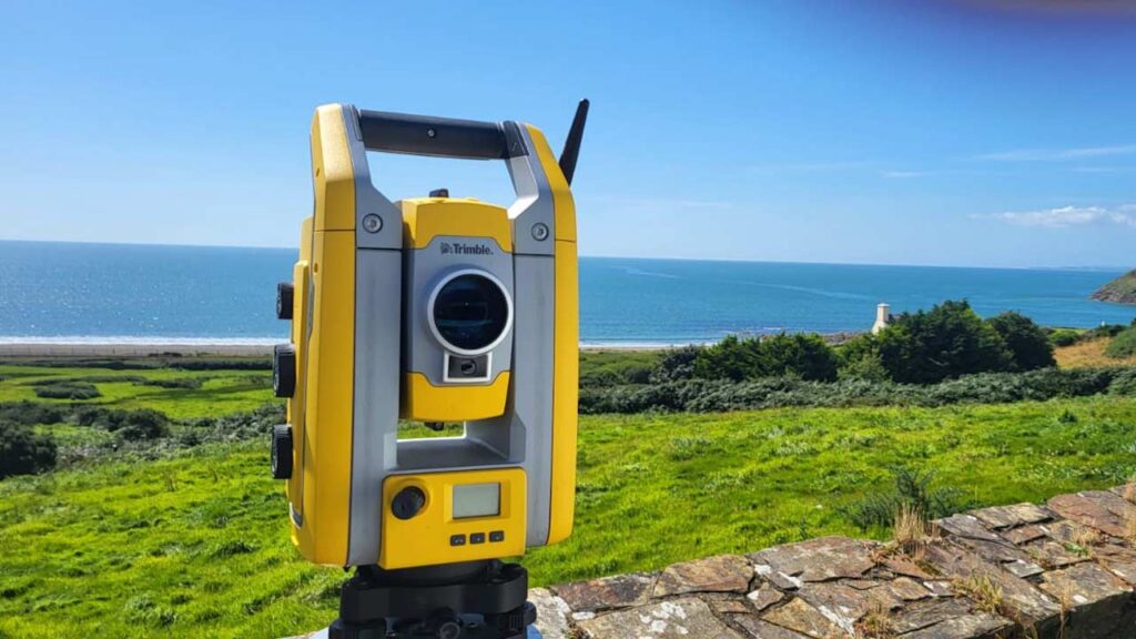 Topographical land survey being completed across a coastal site in South Wales